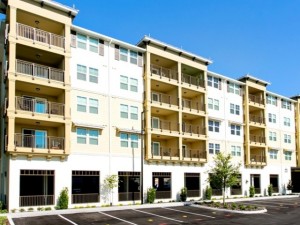 Photo of a five story multifamily building.