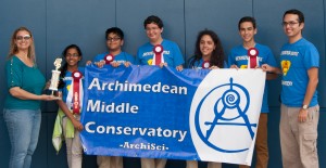 Students holding banner and wearing red ribbons.