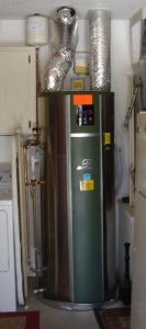 Heat pump water heater inside laundry room of house, photo.