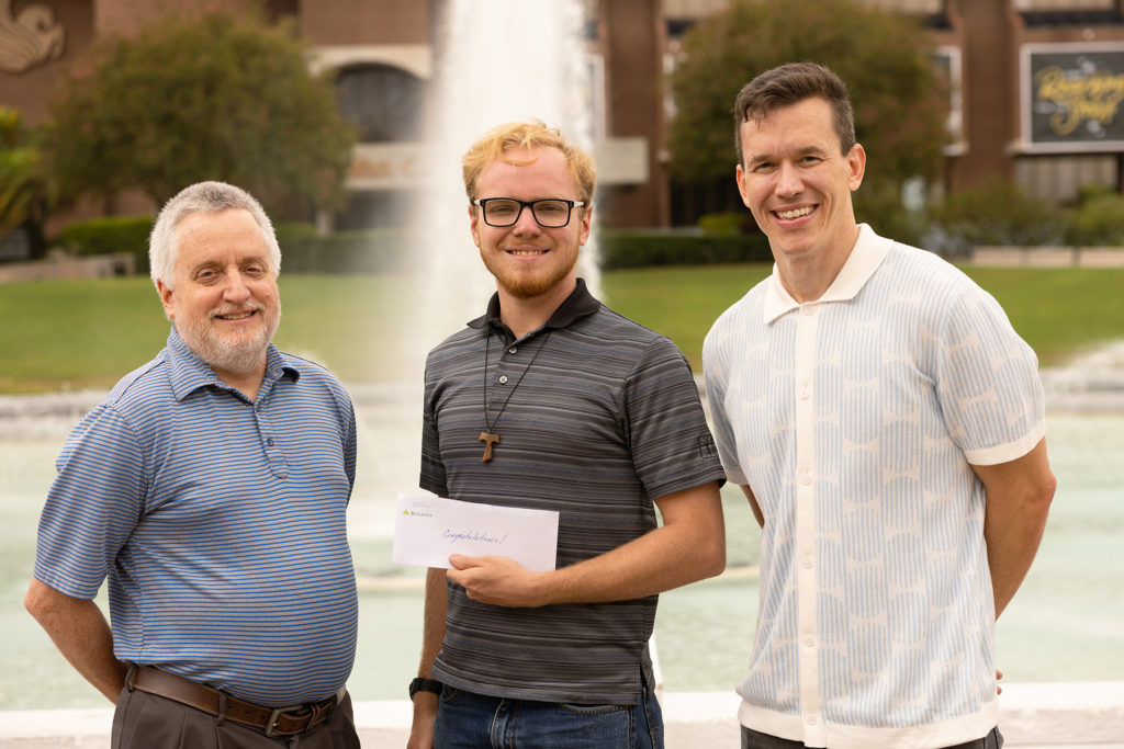 Tim Gallagher (center) stands with his dad, Patrick Gallagher (left) and his supervisor (right), Kristopher Davis, UCF professor and director of Solar Energy Research at FSEC.